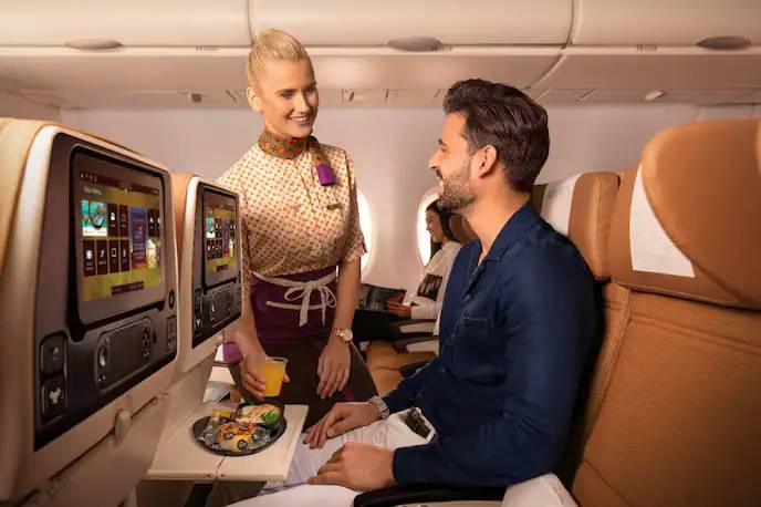 economy passenger eating meal on Etihad Airways. 